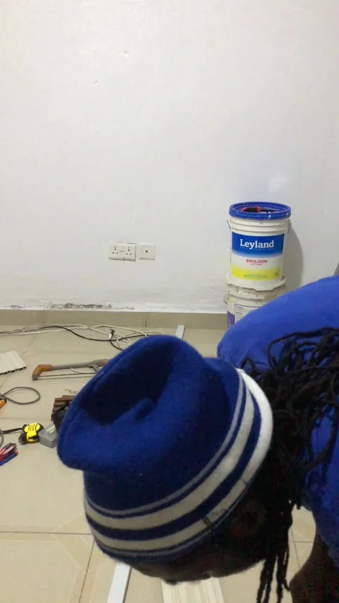 Cutting and Installing of Wall panel /wall paper in Accra, Ghana. March 26,2025 Stock Footage 318505391