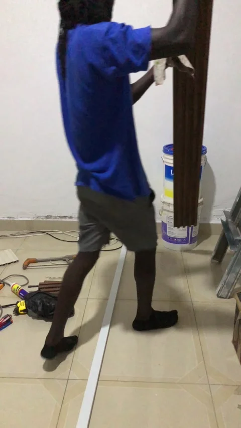 Cutting and Installing of Wall panel /wall paper in Accra, Ghana. March 26,2025 Stock Footage 318505651