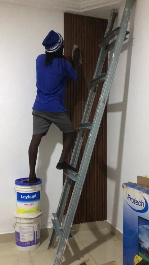 Cutting and Installing of Wall panel /wall paper in Accra, Ghana. March 26,2025 Stock Footage 318505912