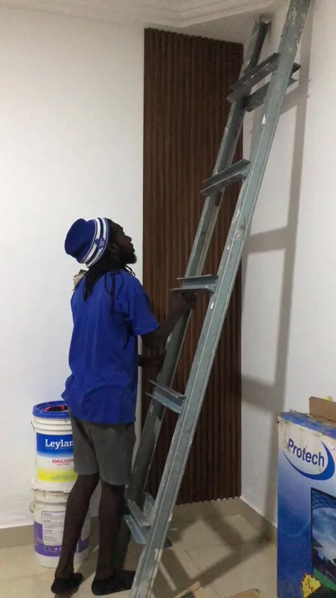 Cutting and Installing of Wall panel /wall paper in Accra, Ghana. March 26,2025 Stock Footage 318505918