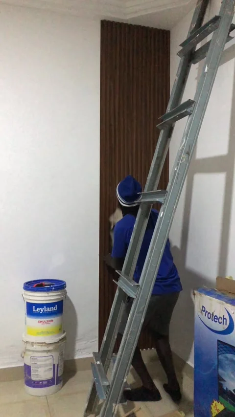 Cutting and Installing of Wall panel /wall paper in Accra, Ghana. March 26,2025 Stock Footage 318506246