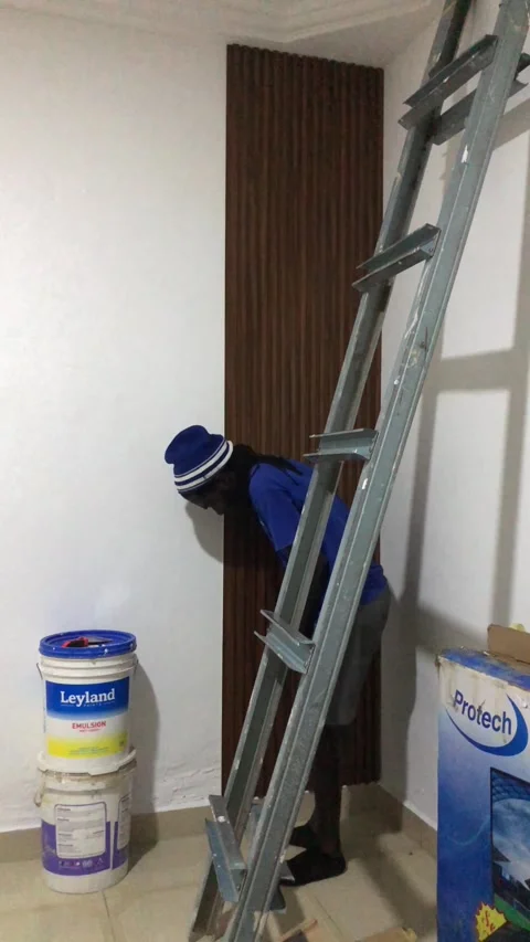 Cutting and Installing of Wall panel /wall paper in Accra, Ghana. March 26,2025 Stock Footage 318506249