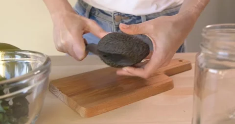 Cutting and pealing avocado Stock Footage 148182993