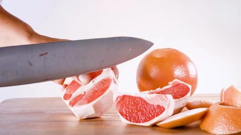Cutting and peeling grapefruit timelapse Stock Footage 124444987