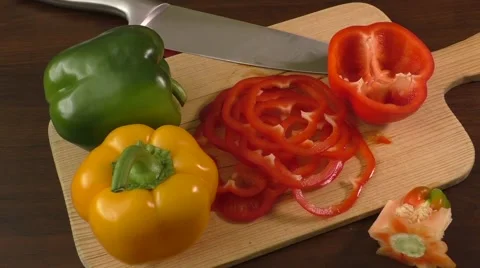 Cutting and preparing bell peppers on a cutting board Stock Footage 58876041