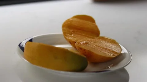 Cutting up and proccessing mango Stock Footage 235581683