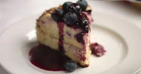 Cutting and serving homemade cake with vanilla cream and blueberries Stock Footage 82994809