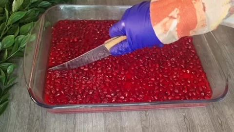 Cutting and Serving Pomegranate Jelly Dessert with Milk Pudding Stock Footage 343878676