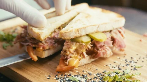 Cutting and serving a pulled pork and mayo sandwich Stock Footage