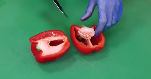 Cutting up and slicing a red pepper on a green board Stock Footage 289411126