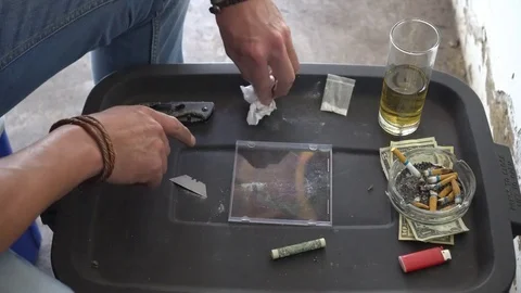 Cutting and snorting cocaine lines Stock Footage 81863085