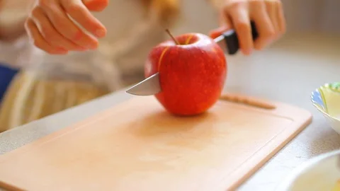 Cutting an apple in halfs, cooking close up video Stock Footage 102814711