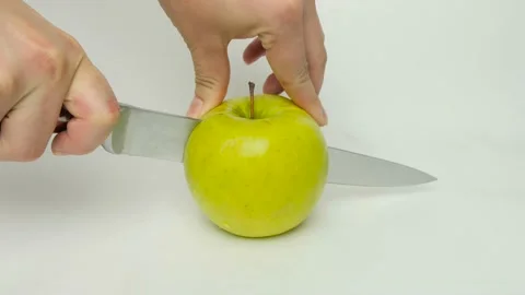 Cutting apple into halves Stock Footage 169173126