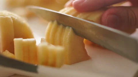 Cutting apple on slices. Preparing ingredients for baking apple pie. Chef Stock Footage 128587874