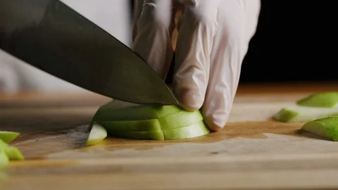 Cutting apples with chef knife macro shot Stock-Footage 128490421