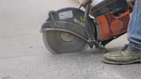 Cutting asphalt with skill saw closeup Stock Footage 104570104