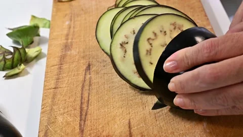 Cutting an aubergine into thin slices Stock Footage 219878347