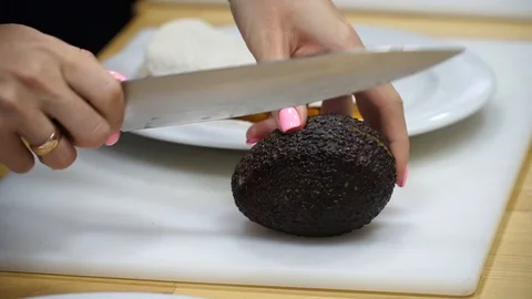 Cutting avacado in the kitchen. Stock Footage 100629878
