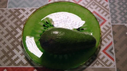 Cutting Avocado on green plate, hands of chef Video stock 83520170