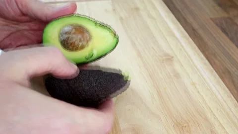 Cutting An Avocado In Half And Taking The Pip Out 스톡 동영상 135468264