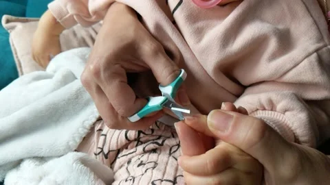 Cutting a baby's nails at home Stock Footage 219735684
