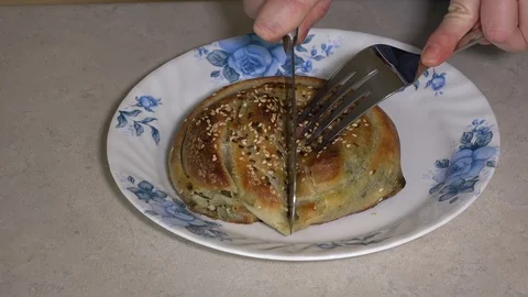 Cutting baked spinach and cheese pie Stock Footage 106648036