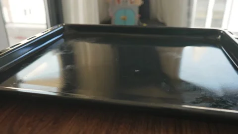 Cutting baking paper and coating baking pan. Kitchen utensils. Baking paper. Non Stock Footage 186432871