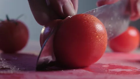 Cutting beautiful red tomato using kitchen knife, water drops macro video. Fresh Stock-Footage 148241268