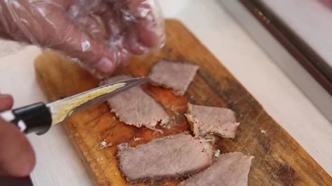 Cutting beef and putting it in a white bowl for soto mie Stock Footage 270347154