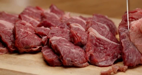 Cutting beef with chef knife close up, cooking process Video stock 126258064