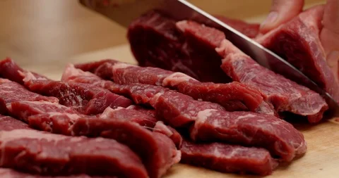 Cutting beef with chef knife close up, cooking process Stock Footage 126258082