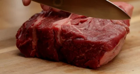 Cutting beef with chef knife close up, cooking process Stock Footage 126258186
