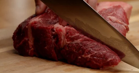 Cutting beef with chef knife close up, cooking process Stock Footage 126258246