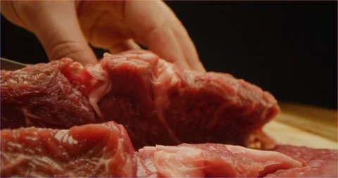 Cutting beef with chef knife macro shot Stock Footage 126292390