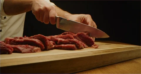 Cutting beef with chef knife macro shot Stockbeeldmateriaal 126292423