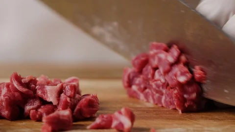 Cutting beef with chef knife macro shot, preparing ingredients for Tar Tar Stock Footage 128488030