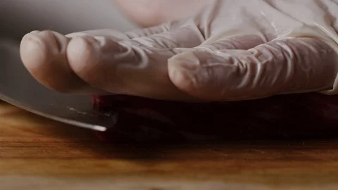 Cutting beef with chef knife macro shot, preparing ingredients for Tar Tar Stock-Footage 128488415