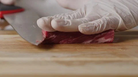Cutting beef with chef knife macro shot, preparing ingredients for Tar Tar Stock-Footage 128488449