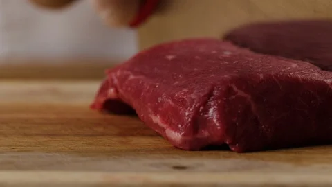 Cutting beef with chef knife macro shot, preparing ingredients for Tar Tar Stock-Footage 128488626