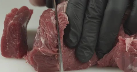 Cutting beef meat into pieces closeup Stock Footage 151278252