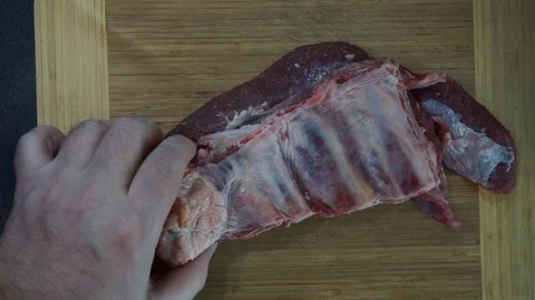 Cutting beef ribs overhead Stock Footage 120462217
