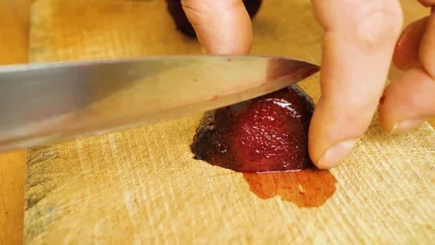 Cutting beet with sharp chef knife macro shot, cooking process, preparing Stock Footage 126064871