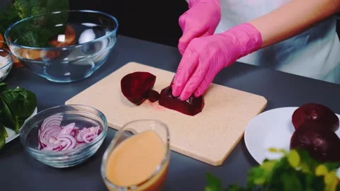 Cutting beetroot into pieces on a cutting board Видео 252221807