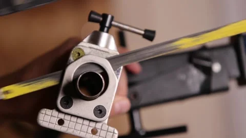 Cutting a bicycle fork metal steerer tube with a hacksaw blade close up Stock Footage 307453158