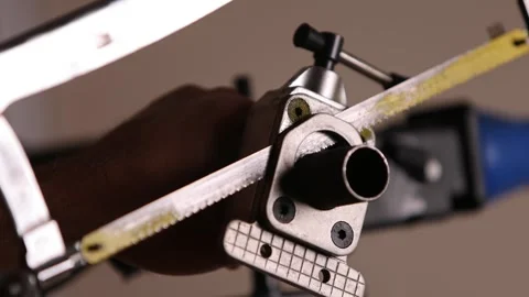 Cutting a bicycle fork metal steerer tube with a hacksaw blade close up Stock Footage 307453239