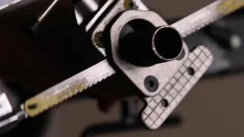 Cutting a bicycle fork metal steerer tube with a hacksaw blade close up Stock Footage 307453822