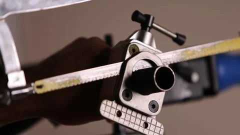 Cutting a bicycle fork metal steerer tube with a hacksaw blade close up Stock Footage 307459844