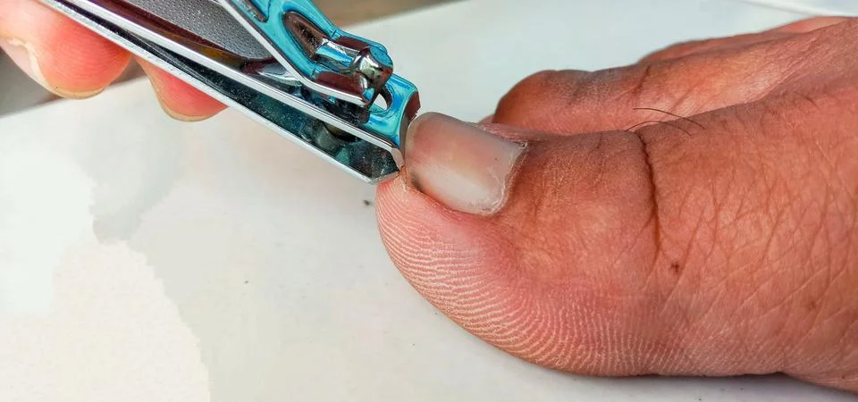 Cutting the big toe nails Stock Photos