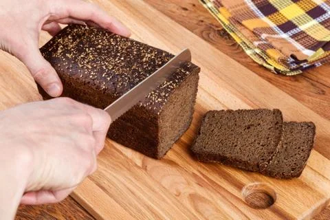 Cutting Black Bread Stock Photos