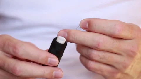 Cutting a black thread from a bobbin Stock Footage 73506123